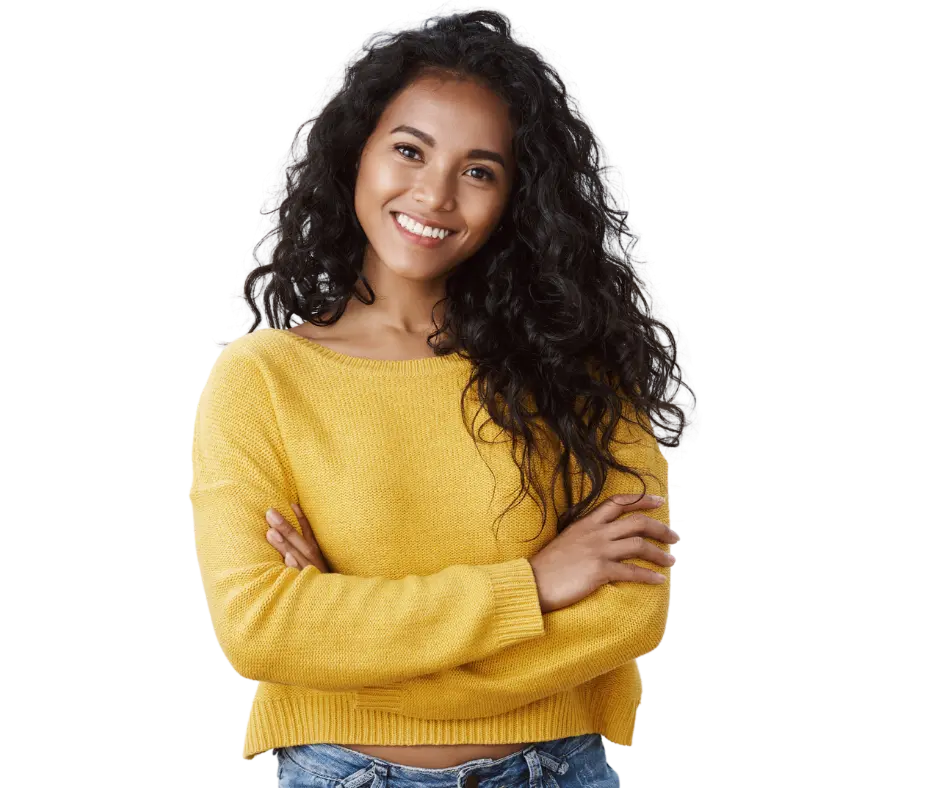 Jeune femme aux cheveux longs bouclé noirs, souriant les bras croisés